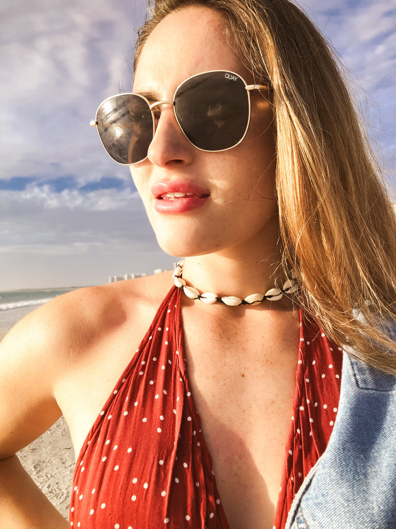 cowrie shell necklace on women at beach