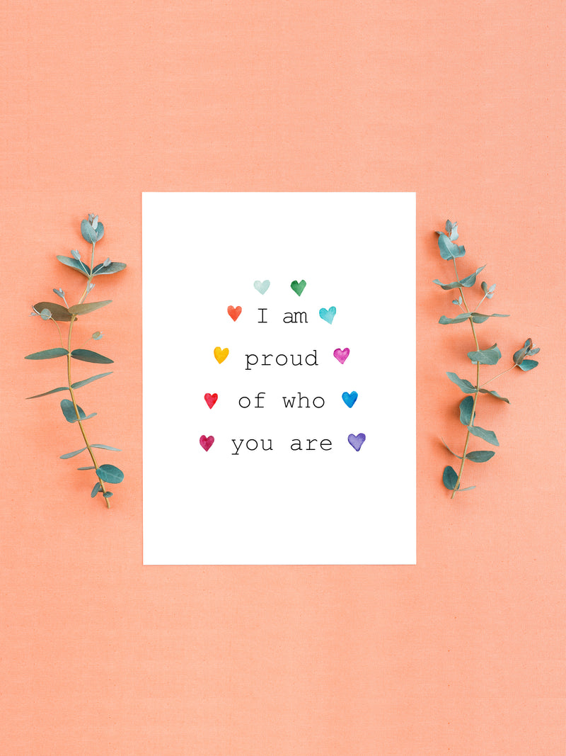 I am proud of you rainbow LGBTQ+ Pride card. Delicate multi color hearts around the Title in a rainbow fashion