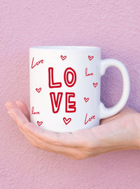 red love hearts coffee mug.  Red love lettering all around. C handle